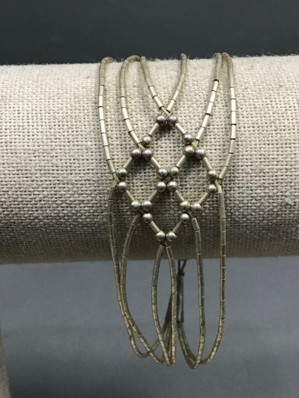 sterling silver liquid silver bracelet featuring a woven diamond design.